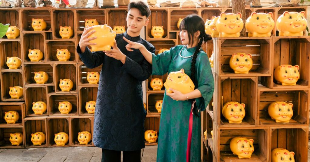 Couple in traditional Vietnamese attire with piggy banks in Hội An setting.