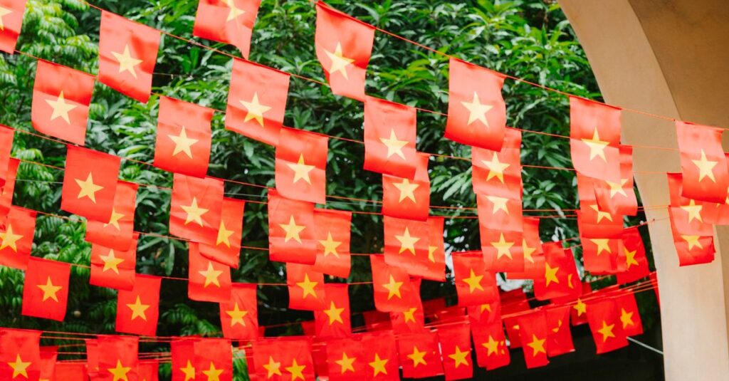 Rows of vibrant Vietnamese flags with yellow stars hanging outdoors under trees.