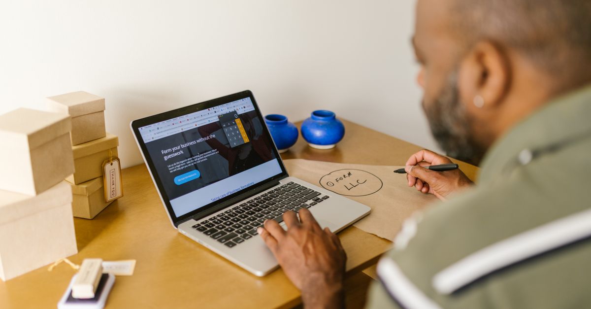 Entrepreneur at a desk using a laptop for business planning. Ideal for tech and startup themes.