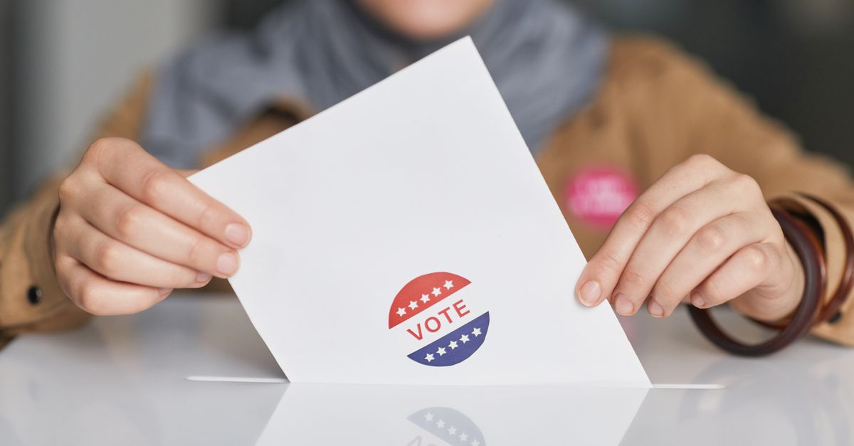 Close-up of hands holding a vote ballot, symbolizing election participation.