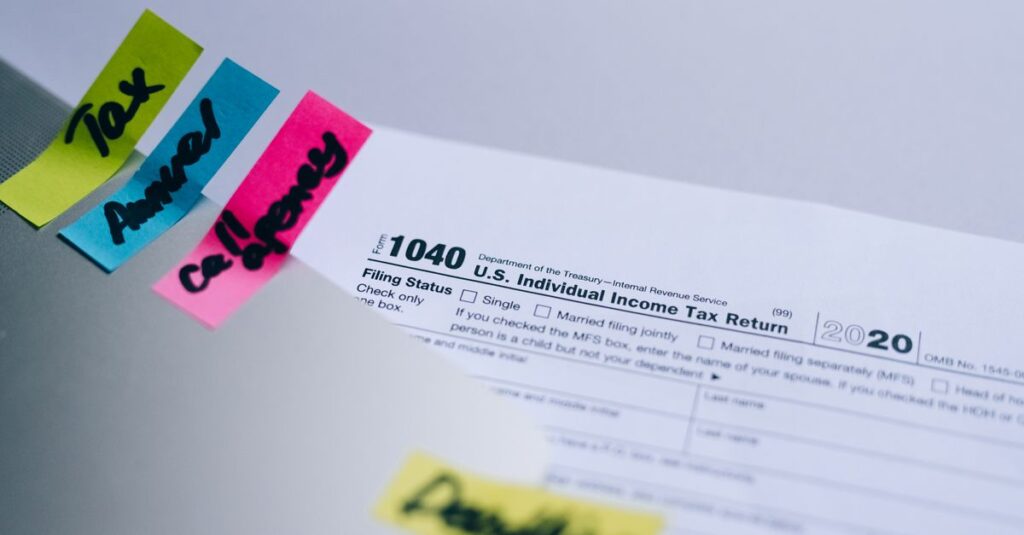 Close-up of 1040 U.S. tax form with colorful sticky notes for organization.