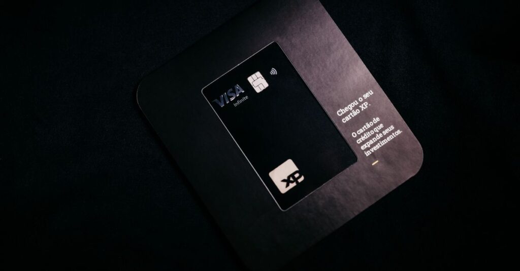 A Visa XP black credit card displayed on a dark background, emphasizing finance and security.