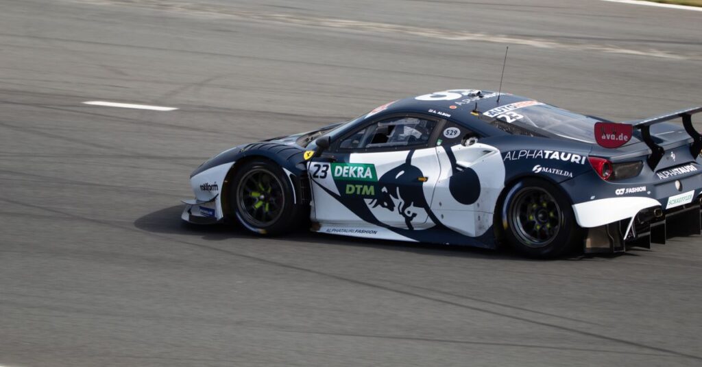 Dynamic sports car speeding on a race track during a tournament.