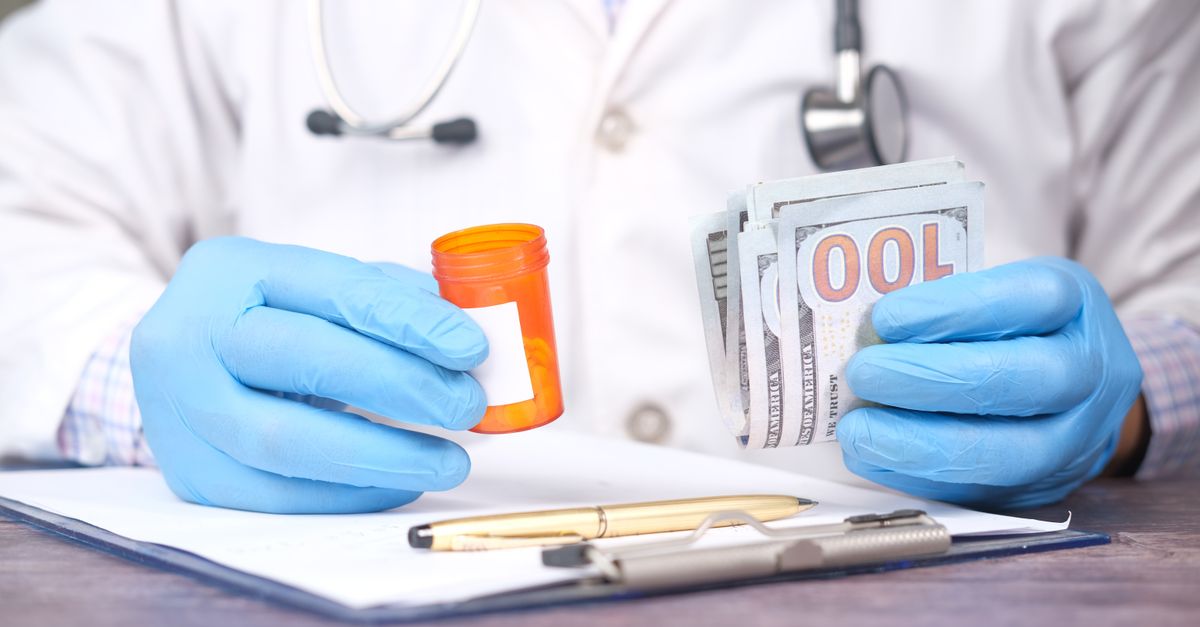 Doctor in gloves holding pill bottle and cash, highlighting medical expenses.
