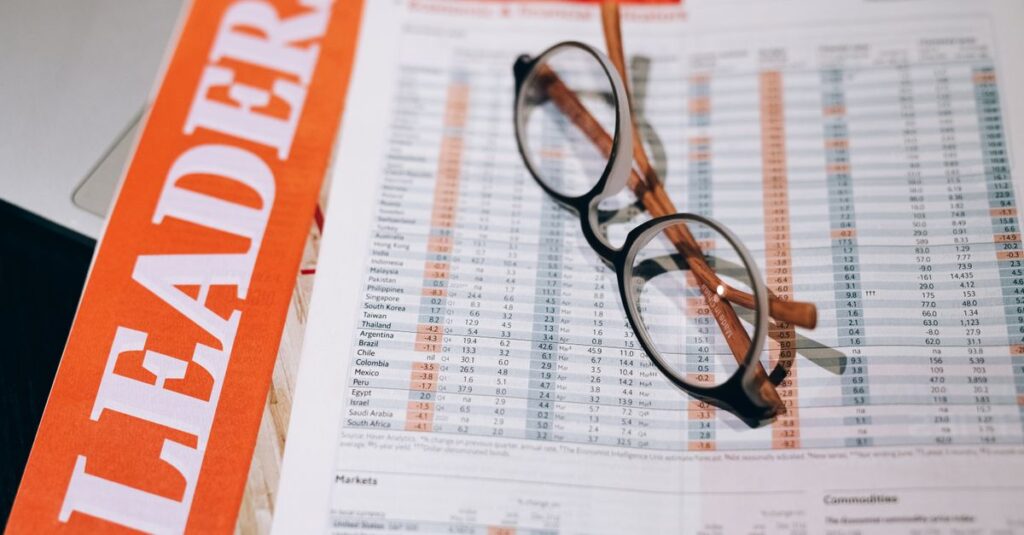 Close-up of financial documents with eyeglasses, depicting data analysis and business insights.